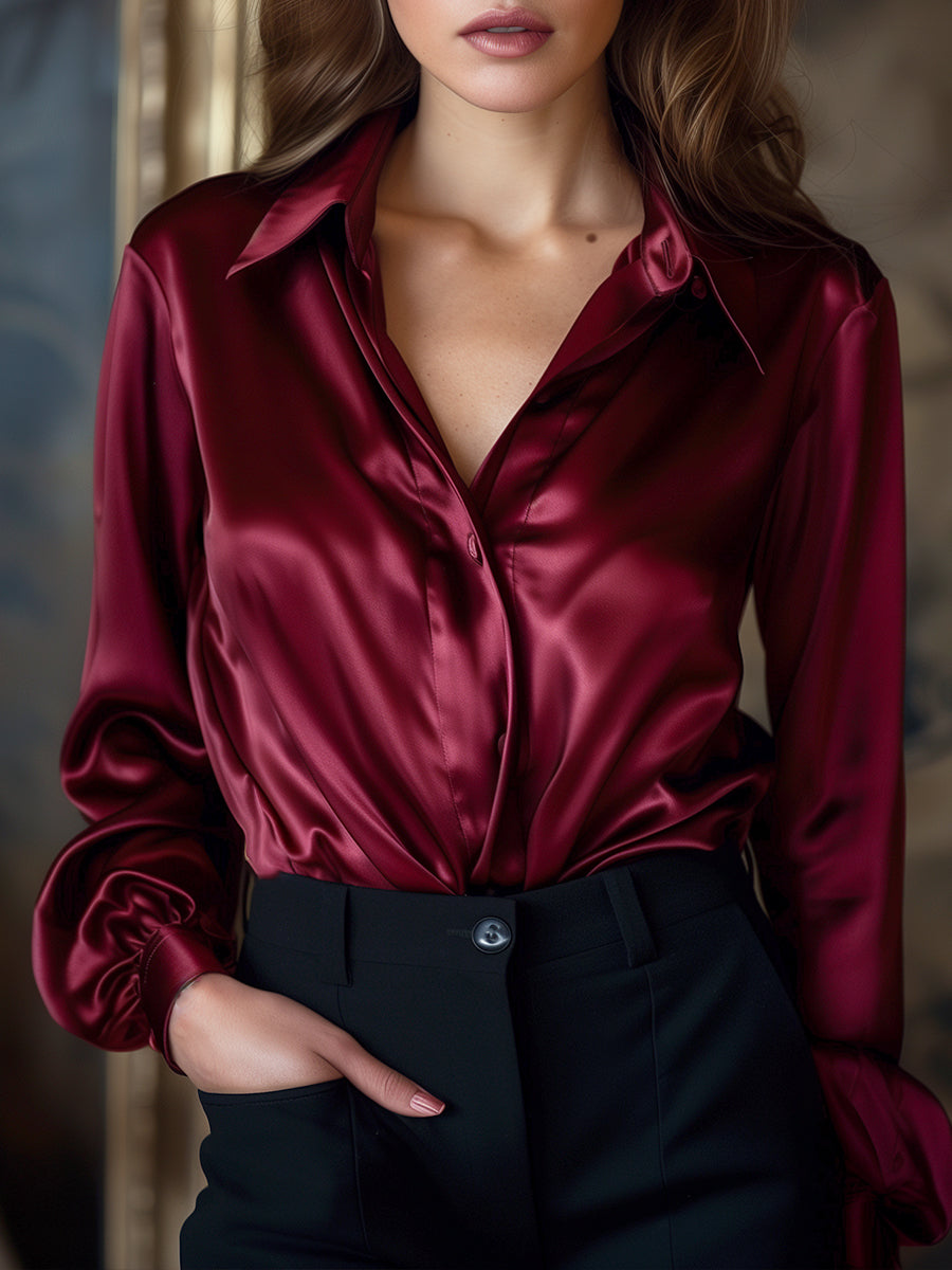 Elegante schwarze Satinbluse mit langen Ärmeln