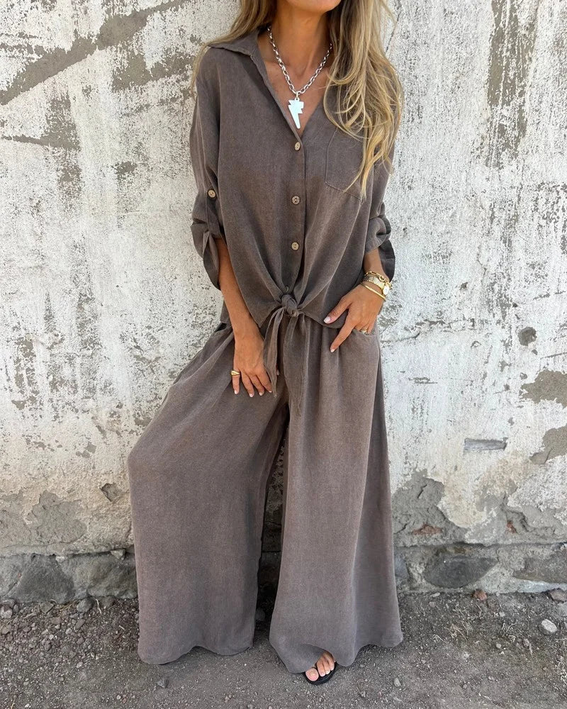 Elegantes Damen-Sommeroutfit mit Baggy-Hose und langärmeliger Bluse mit Knöpfen